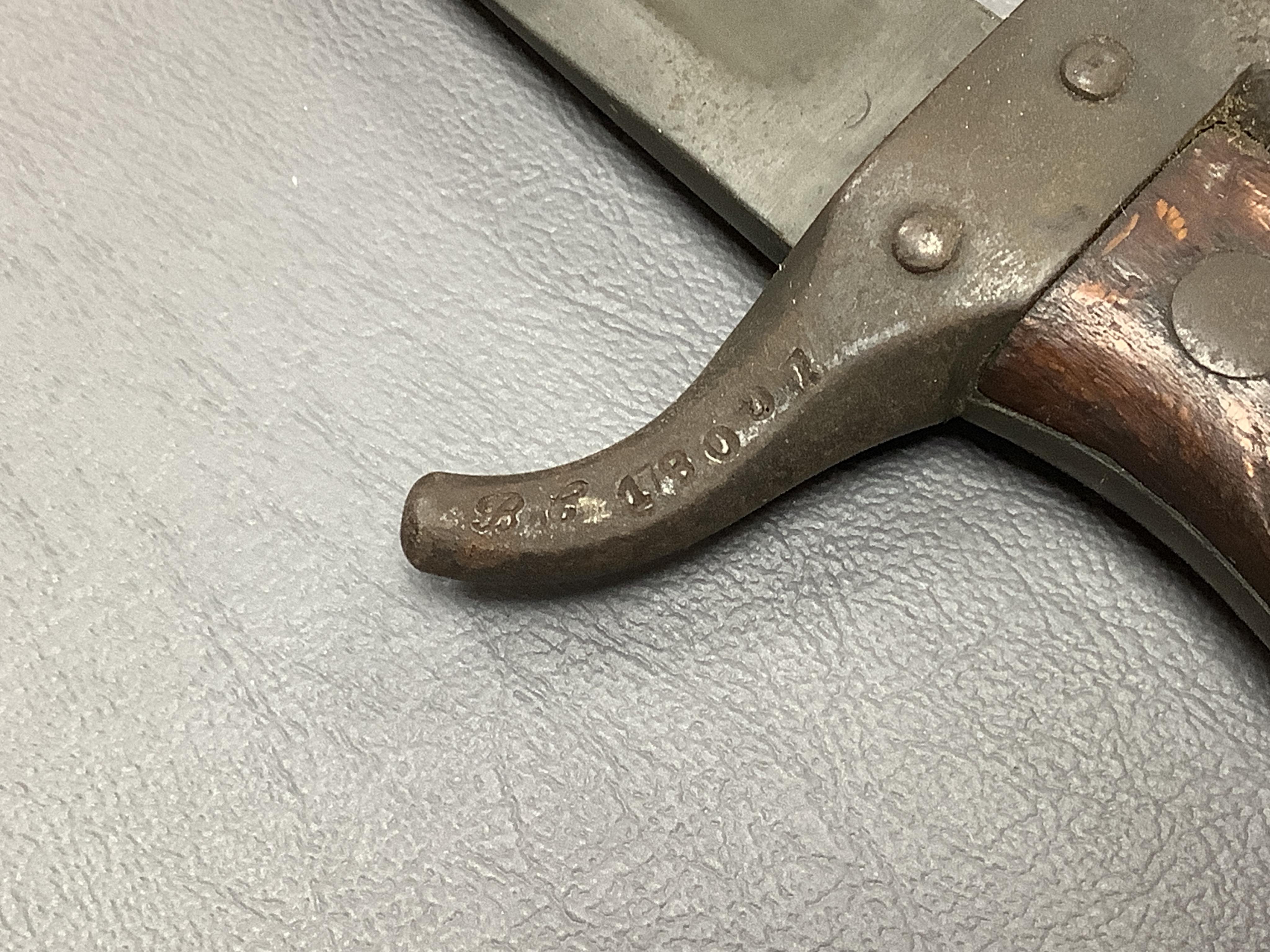 A First World War Turkish army officer’s sword, with pipe back blade, regulation iron guard pierced with crescent and moon, chequered horn grips, in its iron scabbard, together with an unidentified bayonet in its scabbar